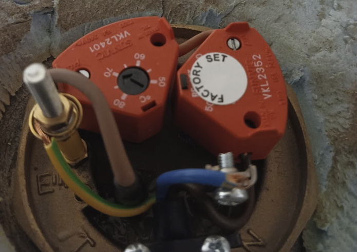 Top of the 1kw immersion element, showing its two thermostats (one user settable, one factory set)