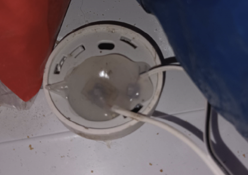 An Aqara with wires soldered to the battery connectors, and sealed using hot-glue