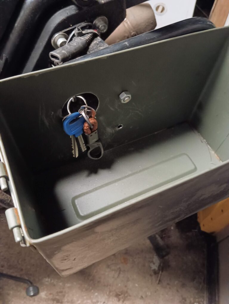 The bit of butyl rubber here is to cover a larger hole on the left hand side box so that I can still reach the keyhole for the seat